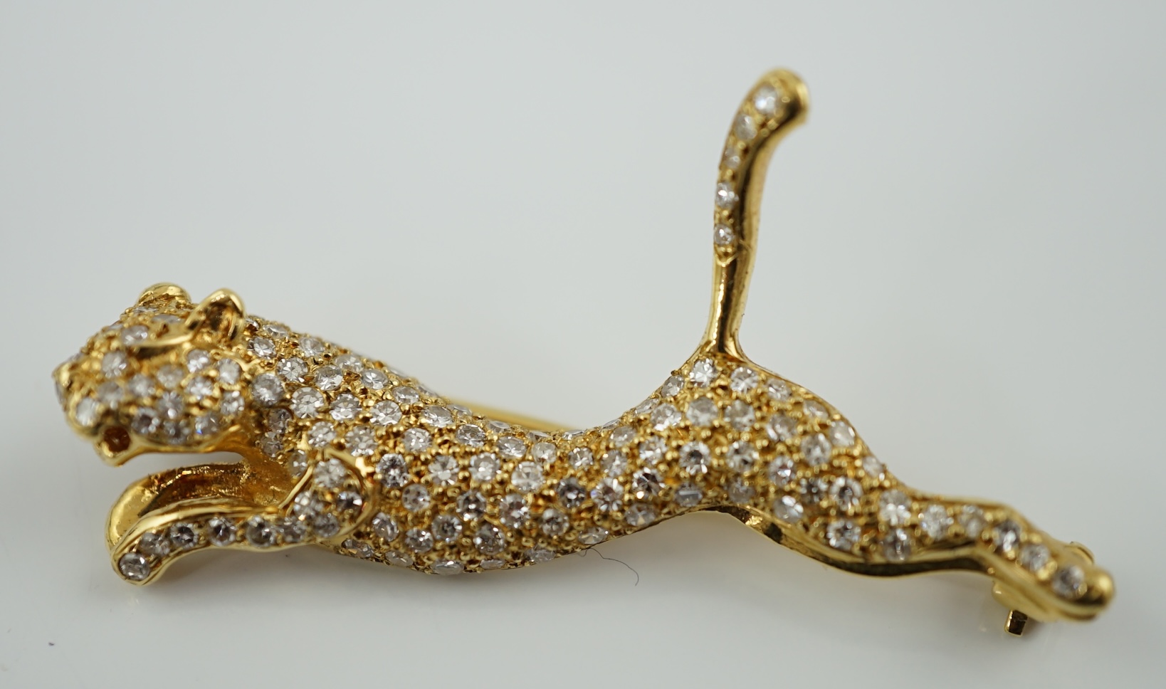 A gold and pave set diamond leaping panther brooch